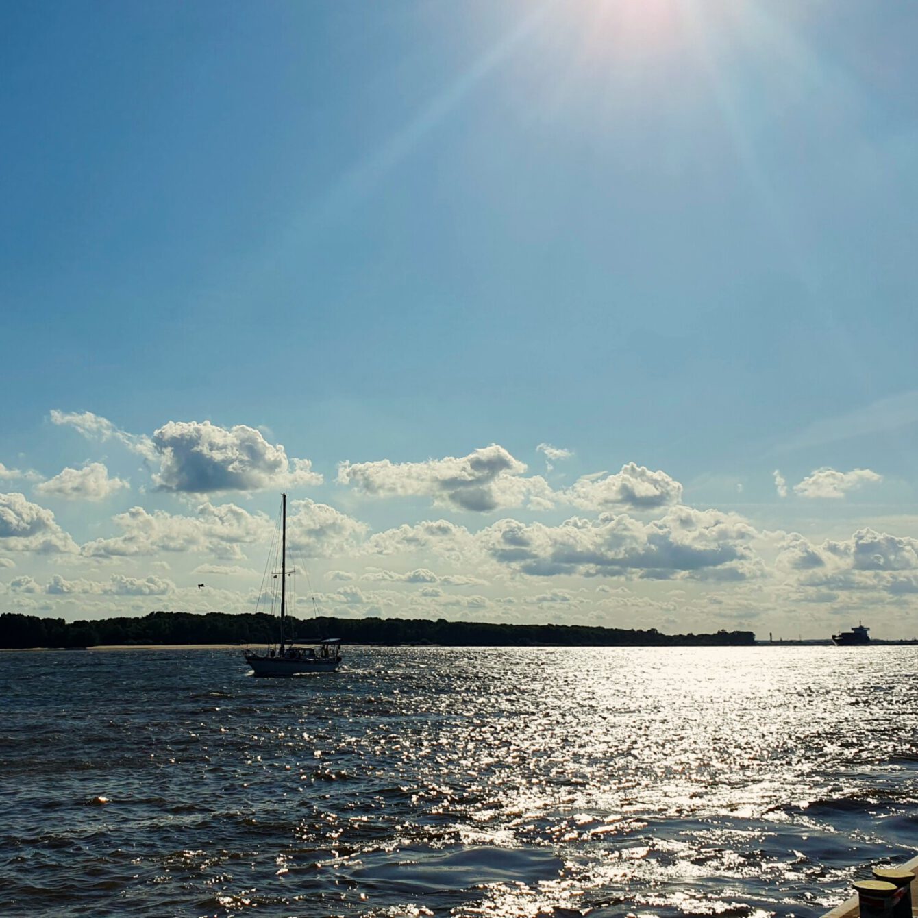 Sun reflecting on the river's surface.